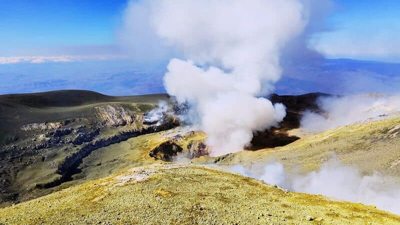 view of bocca nuova crater of Etna volcano smoking gas